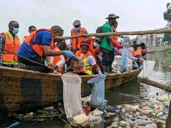 Removing floating waste from a dugout canoe.